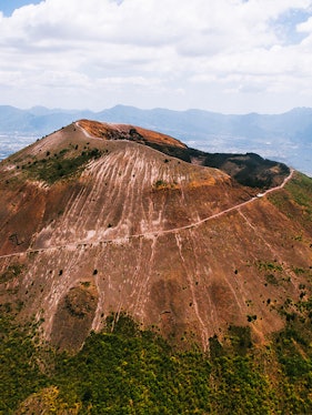 Aerial view of Mount Vesuvius crater with surrounding landscape in Italy.