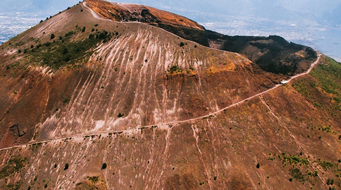 Aerial view of Mount Vesuvius crater with surrounding landscape in Italy.