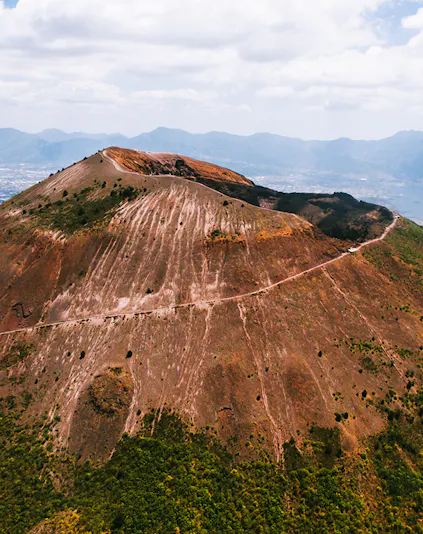 Aerial view of Mount Vesuvius crater with surrounding landscape in Italy.