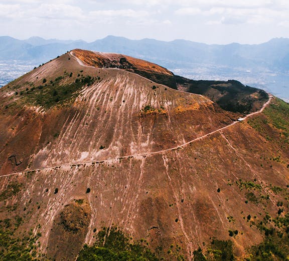 Aerial view of Mount Vesuvius crater with surrounding landscape in Italy.
