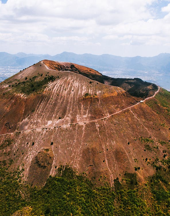Aerial view of Mount Vesuvius crater with surrounding landscape in Italy.