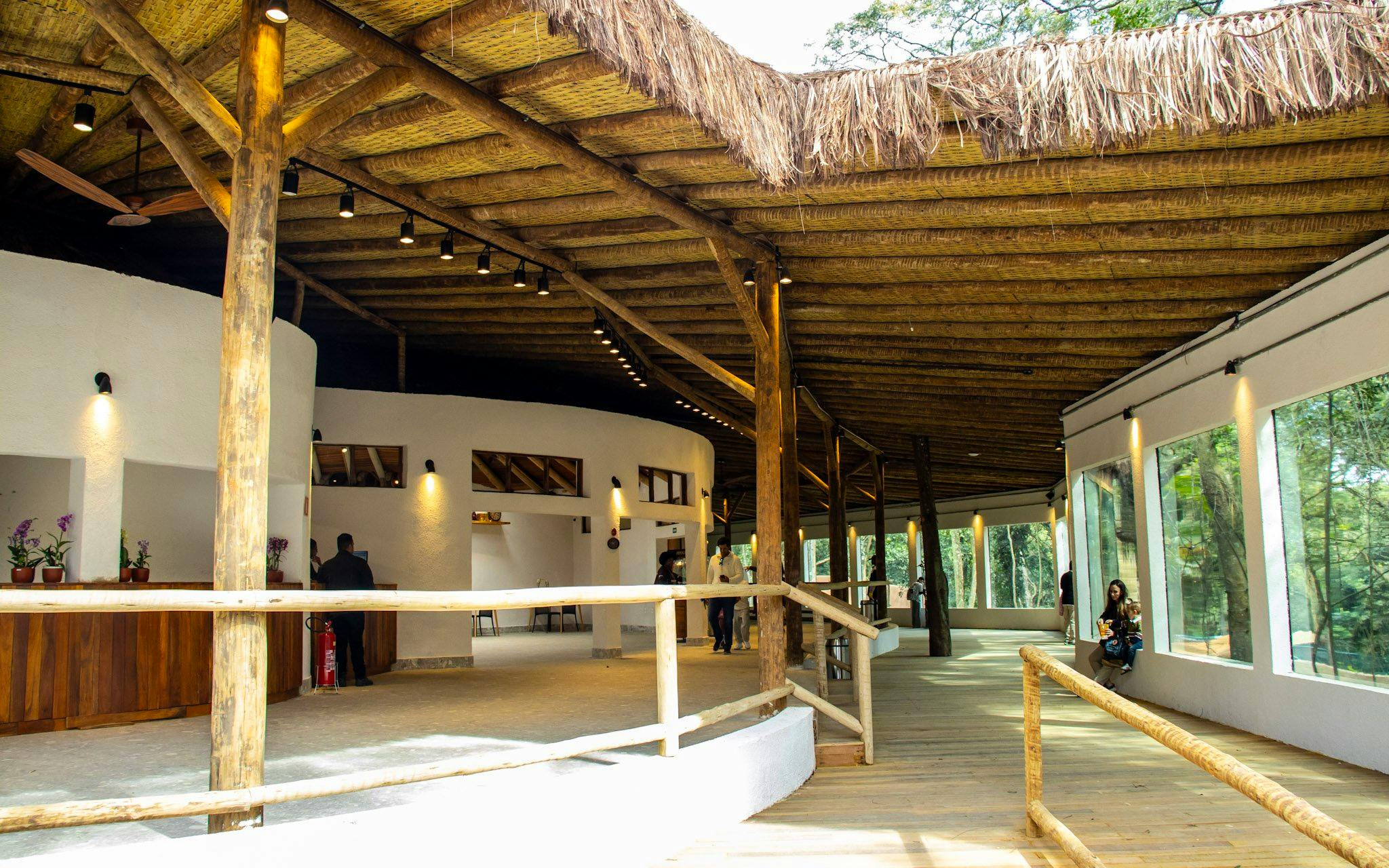 Sao Paulo Zoo entrance area with wooden beams and visitors during Simba Safari.