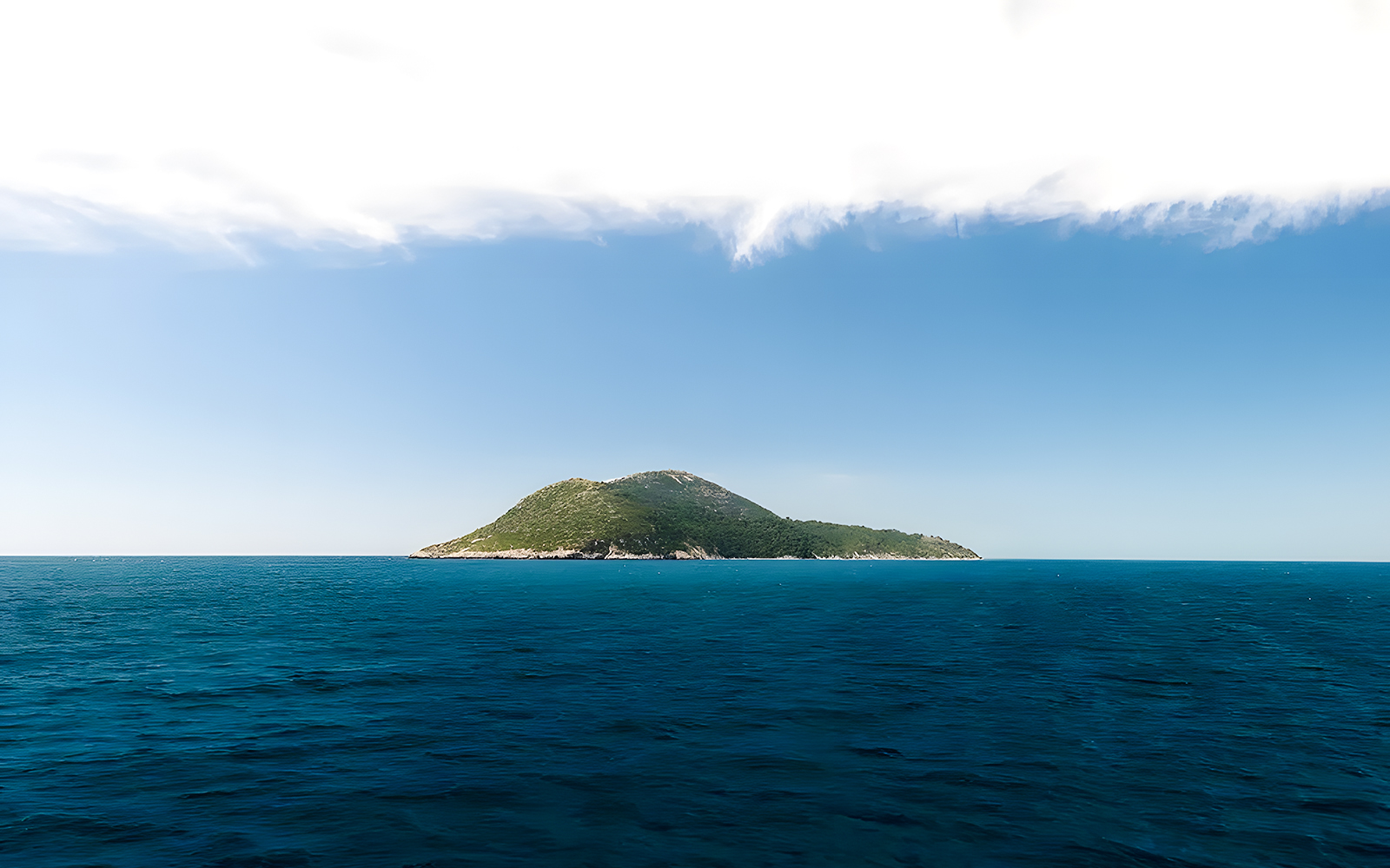 Sazan Island in Albania surrounded by blue sea and clear sky.