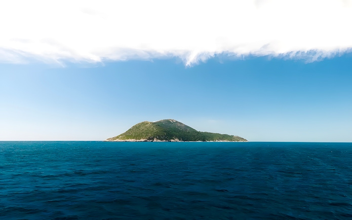Sazan Island in Albania surrounded by blue sea and clear sky.