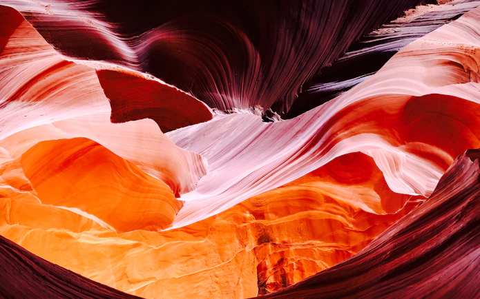 Colorful sandstone formations in Secret Antelope Canyon tour.