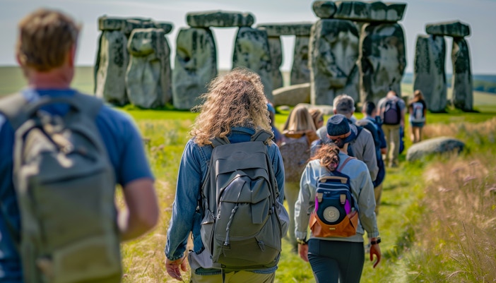 Tourists walking towards Stonehenge in Wiltshire, England.