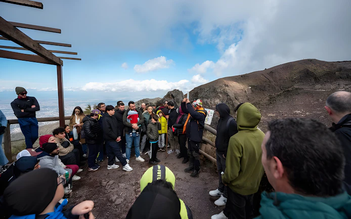 Group of tourists on a guided hike at Vesuvius National Park near Naples, Italy.