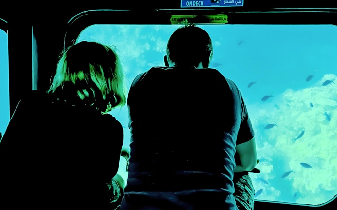 Couple viewing fish through submarine window on Royal Seascope, Hurghada.