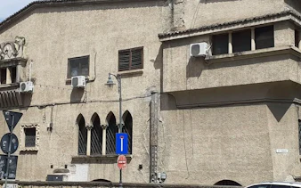 Historic building facade with arched windows in Bucharest, part of the Spy Game city exploration.