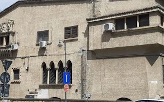 Historic building facade with arched windows in Bucharest, part of the Spy Game city exploration.