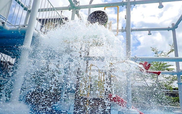 Water splashes from a tipping bucket at Hakone Kowakien Yunessun water park.