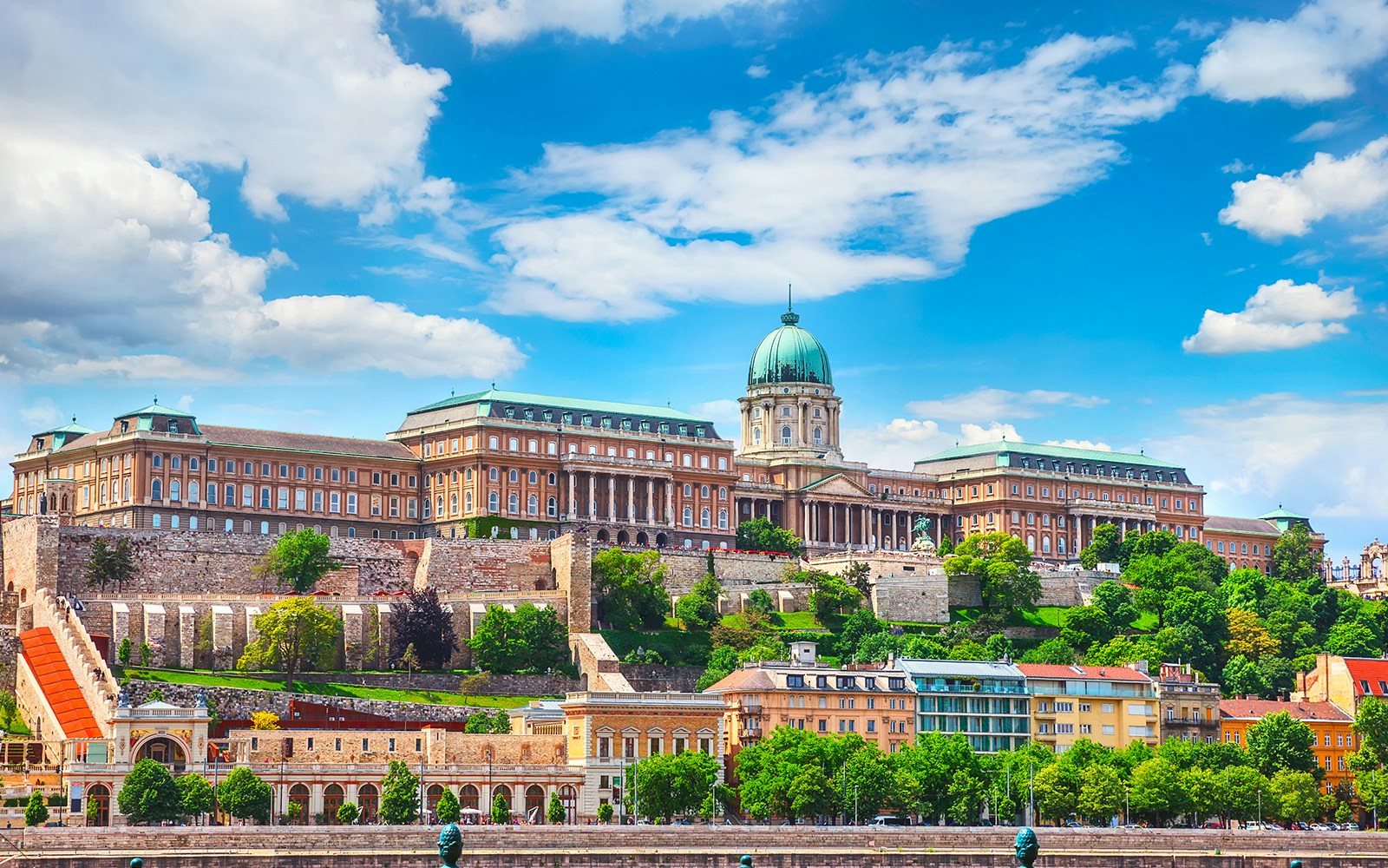 Buda Castle in Budapest with tourists exploring the historic architecture.
