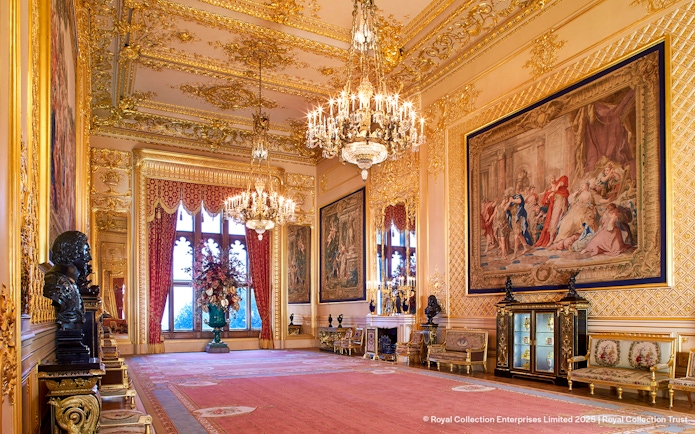 Windsor Castle interior with ornate chandeliers, tapestries, and gilded decor.