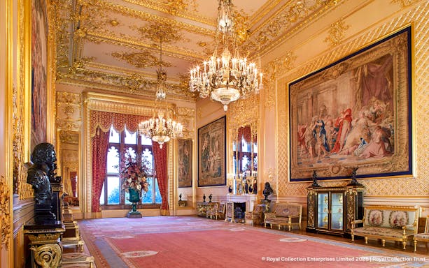 Windsor Castle interior with ornate chandeliers, tapestries, and gilded decor.