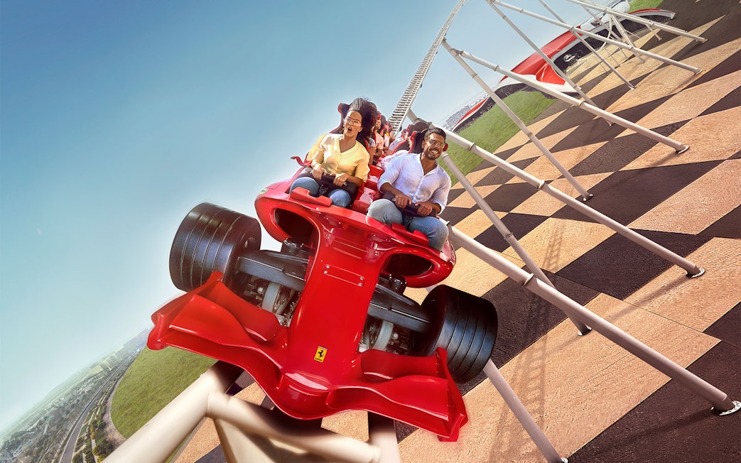 Roller coaster ride at Ferrari World Abu Dhabi with passengers enjoying the thrill.