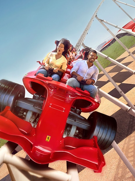 Roller coaster ride at Ferrari World Abu Dhabi with passengers enjoying the thrill.
