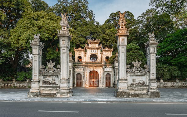 Quan Thanh Temple entrance in Hanoi, featuring ornate stone pillars and traditional architecture.
