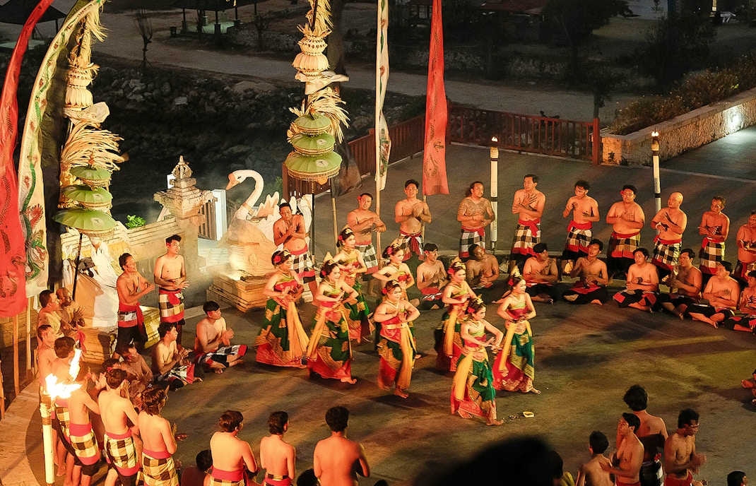 Kecak and Fire Dance performance by the beach in Bali, featuring traditional costumes and chanting circle.