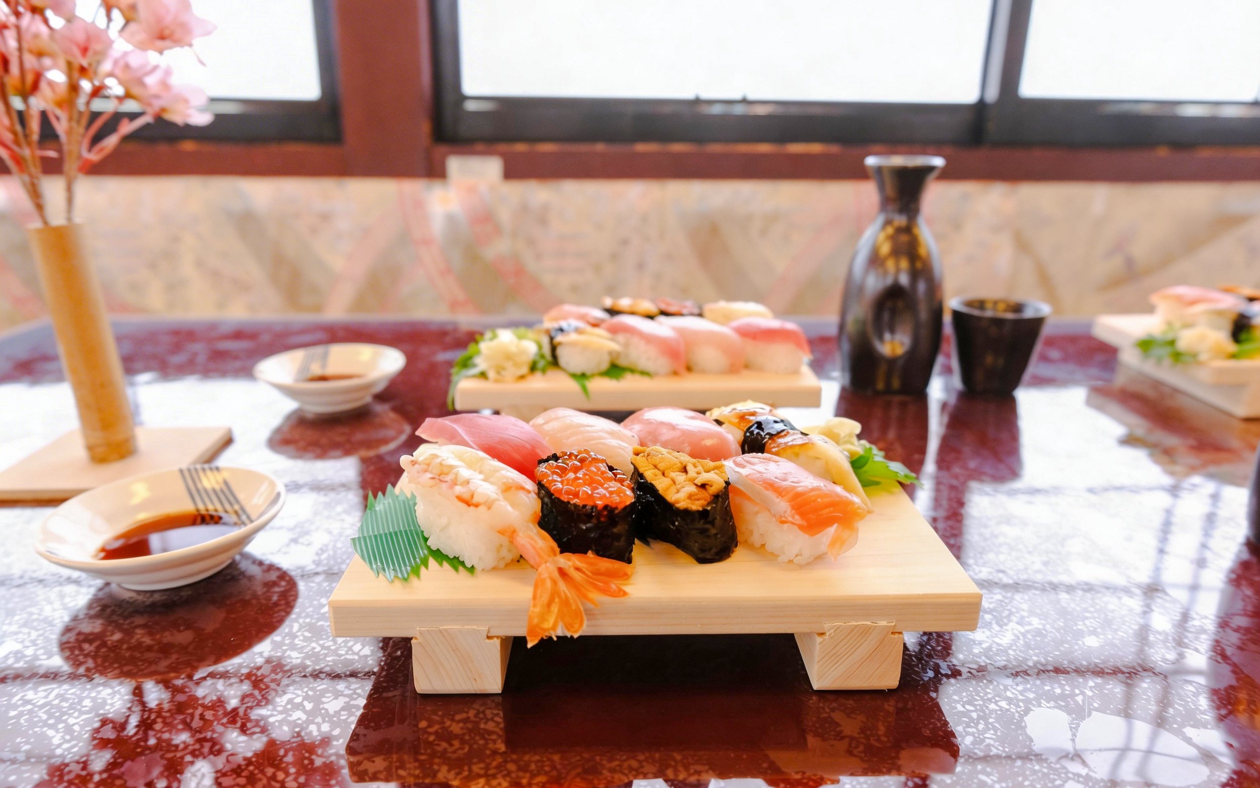 Sushi platter and sake bottles on Tokyo Day Tour: Sakura Cruise.