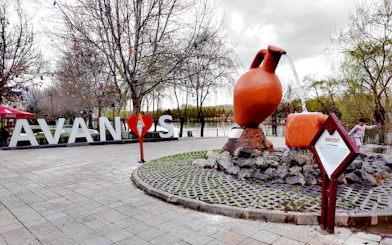Avanos town sign with large pottery sculpture and colorful hanging lights.