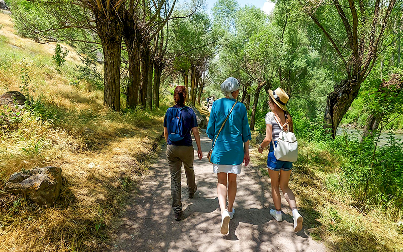Guests walking through a tree-lined path in Gerome Valley, Cappadocia.