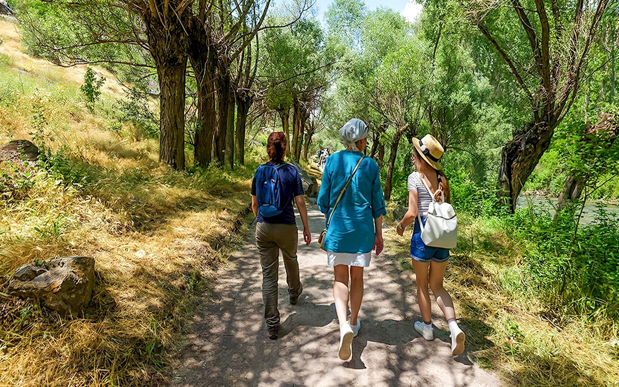 Guests walking through a tree-lined path in Gerome Valley, Cappadocia.