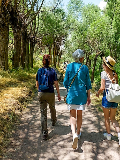 Guests walking through a tree-lined path in Gerome Valley, Cappadocia.