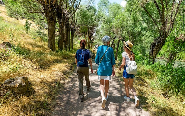 Guests walking through a tree-lined path in Gerome Valley, Cappadocia.