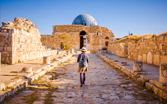 Visitor walking towards the Temple of Hercules at Amman Citadel, Jordan.