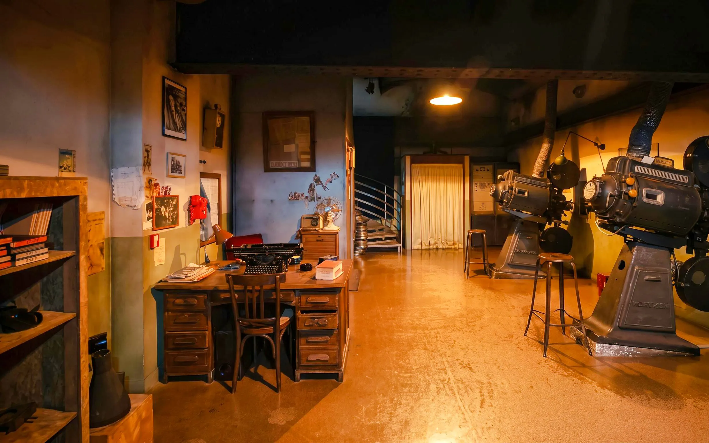 Le Grand Rex cinema studio with vintage projectors and a retro desk setup.