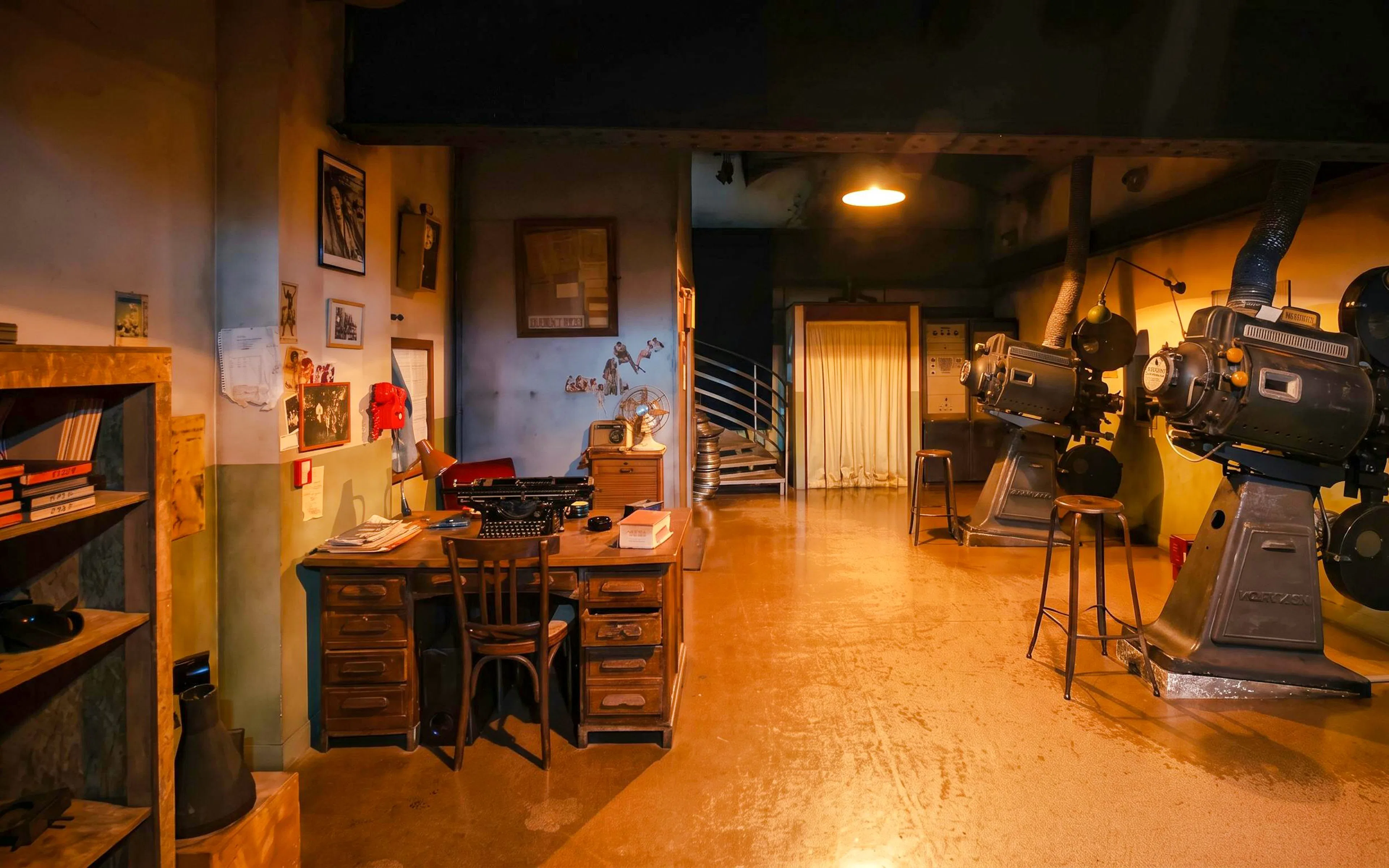 Le Grand Rex cinema studio with vintage projectors and a retro desk setup.
