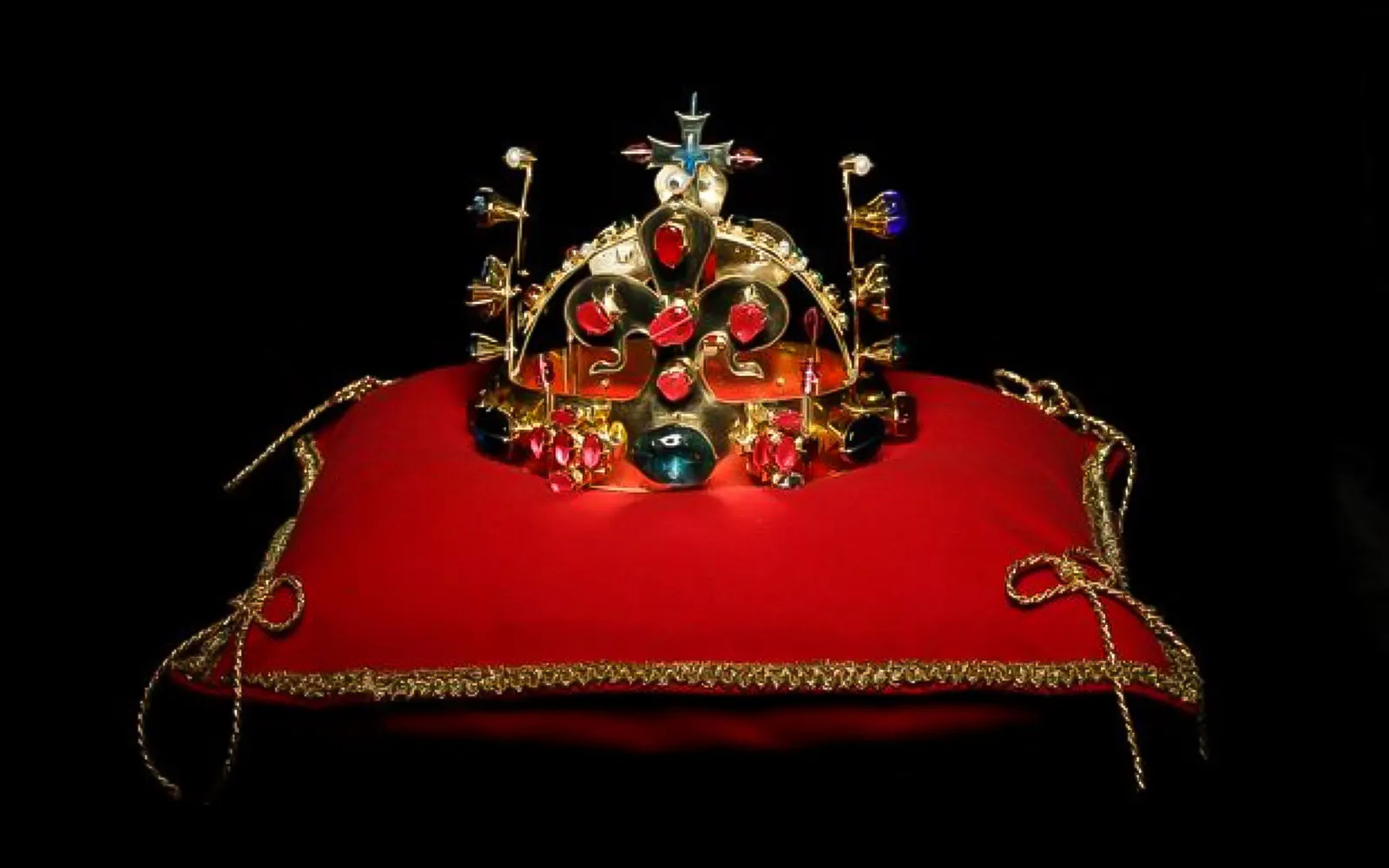 Crown with gemstones on red cushion, exhibit at Minorite monastery of St James, Prague.
