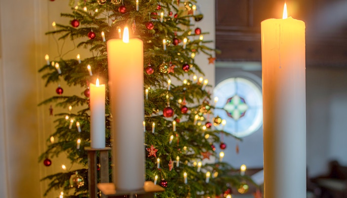 Candle lighting ceremony in a church during Christmas celebration.