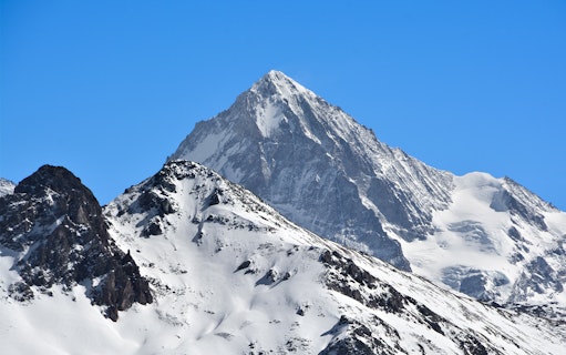Snow-covered Matterhorn peak under clear blue sky.