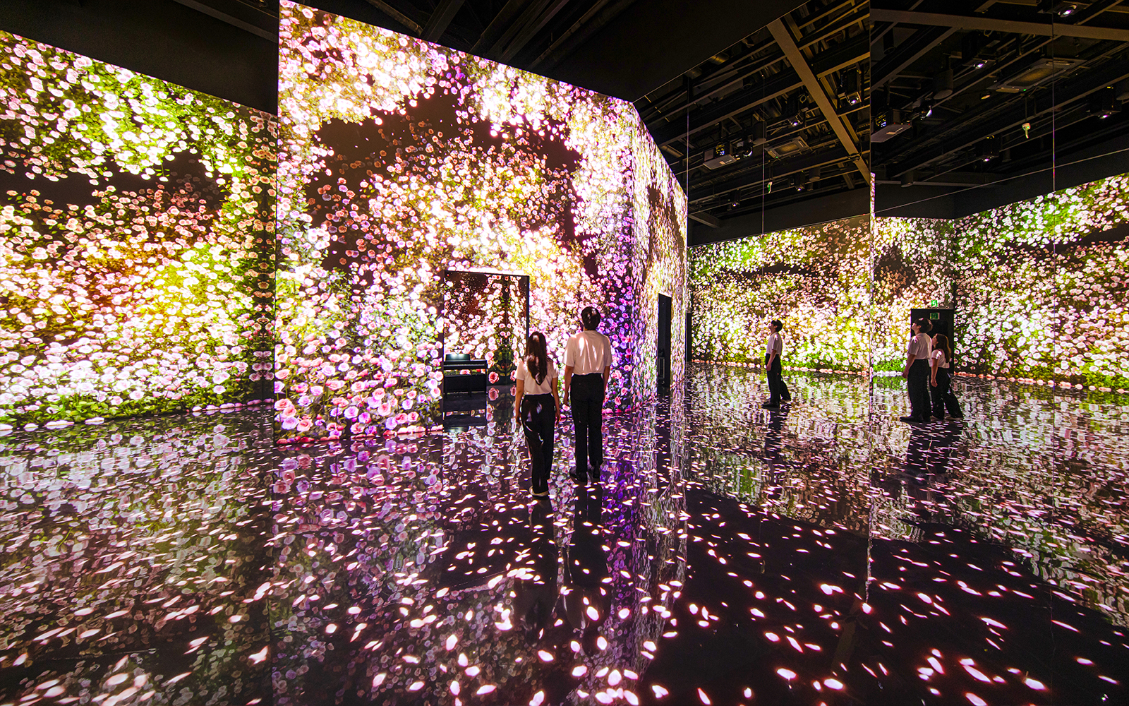 Couple exploring digital flower exhibit at Arte Museum Dubai.
