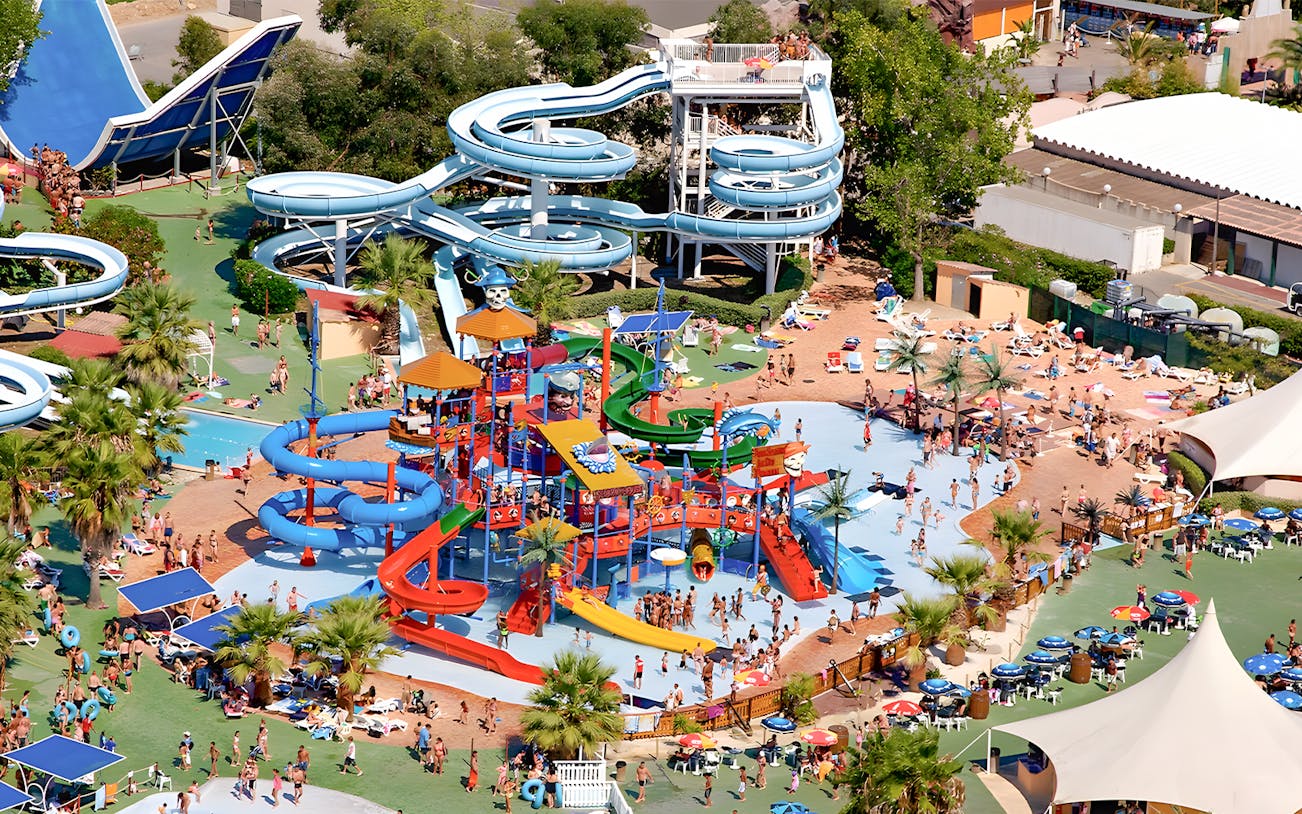 Aquasplash Antibes water park with colorful slides and pools, crowded with visitors enjoying the attractions.