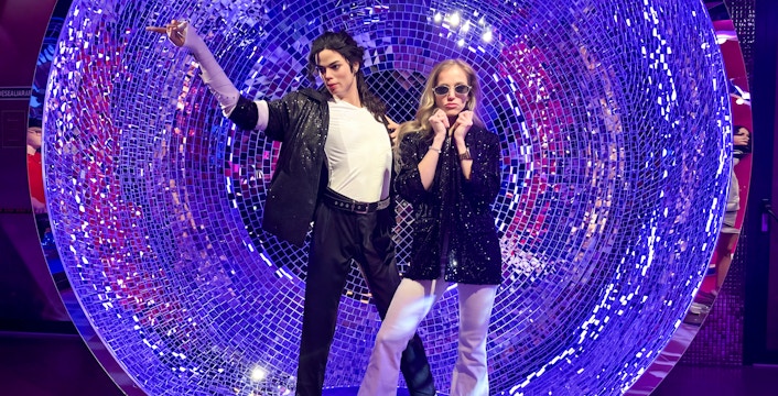 Wax figures in a disco-themed setting at Madame Tussauds Budapest.