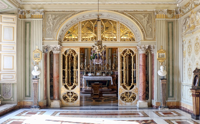 Doria Pamphilj Gallery ornate interior with gilded doors and marble columns.