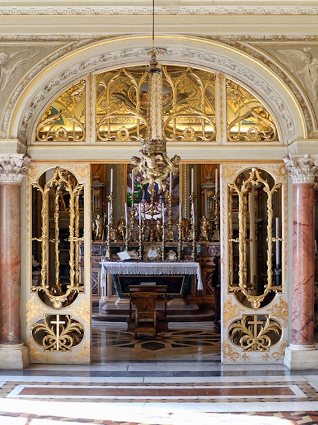 Doria Pamphilj Gallery ornate interior with gilded doors and marble columns.