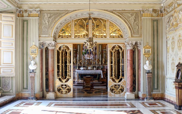 Doria Pamphilj Gallery ornate interior with gilded doors and marble columns.