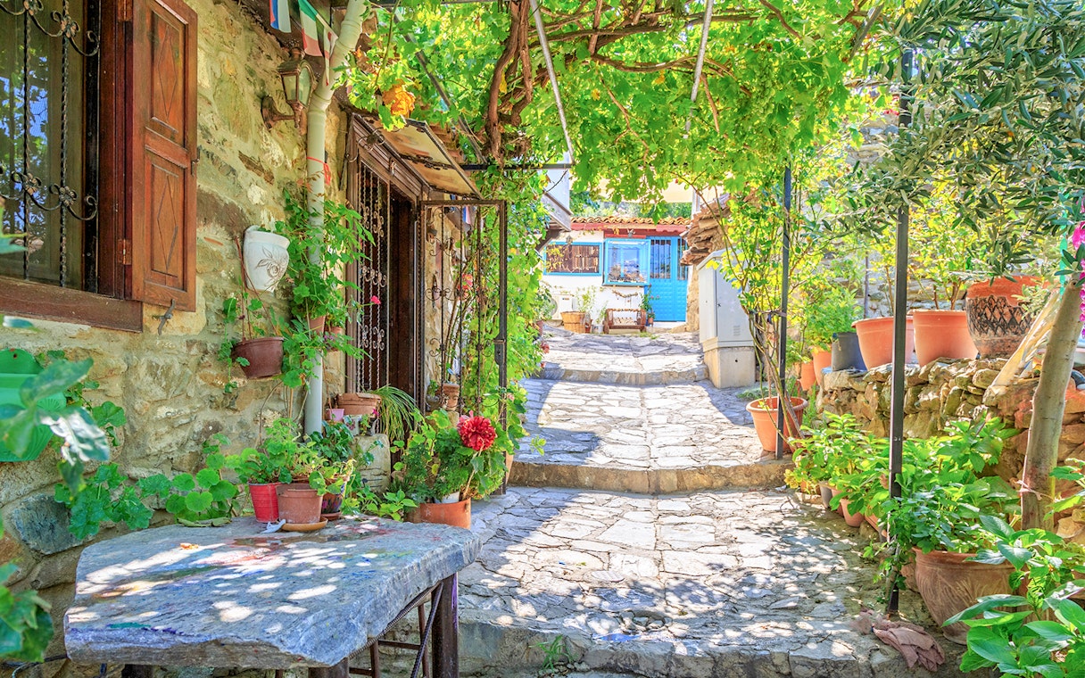 Stone pathway with potted plants in Sirince Village, part of the Ephesus tour from Kusadasi.