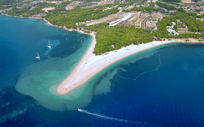 Golden Horn beach extending into the sea with boats near Bol Town, Brac Island.