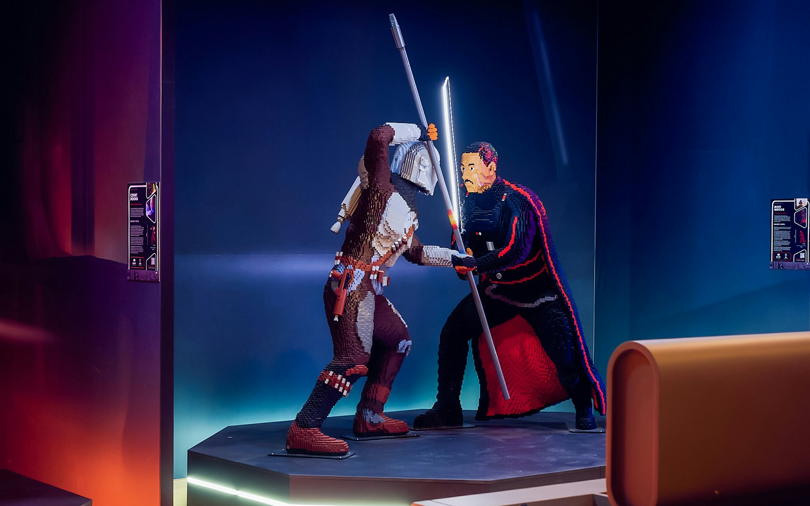 Mandalorian and Moff Gideon LEGO figures in battle at Star Wars exhibition.