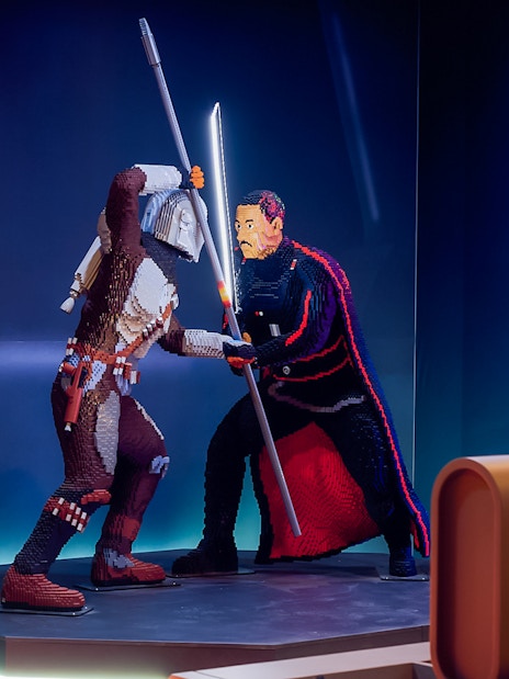 Mandalorian and Moff Gideon LEGO figures in battle at Star Wars exhibition.