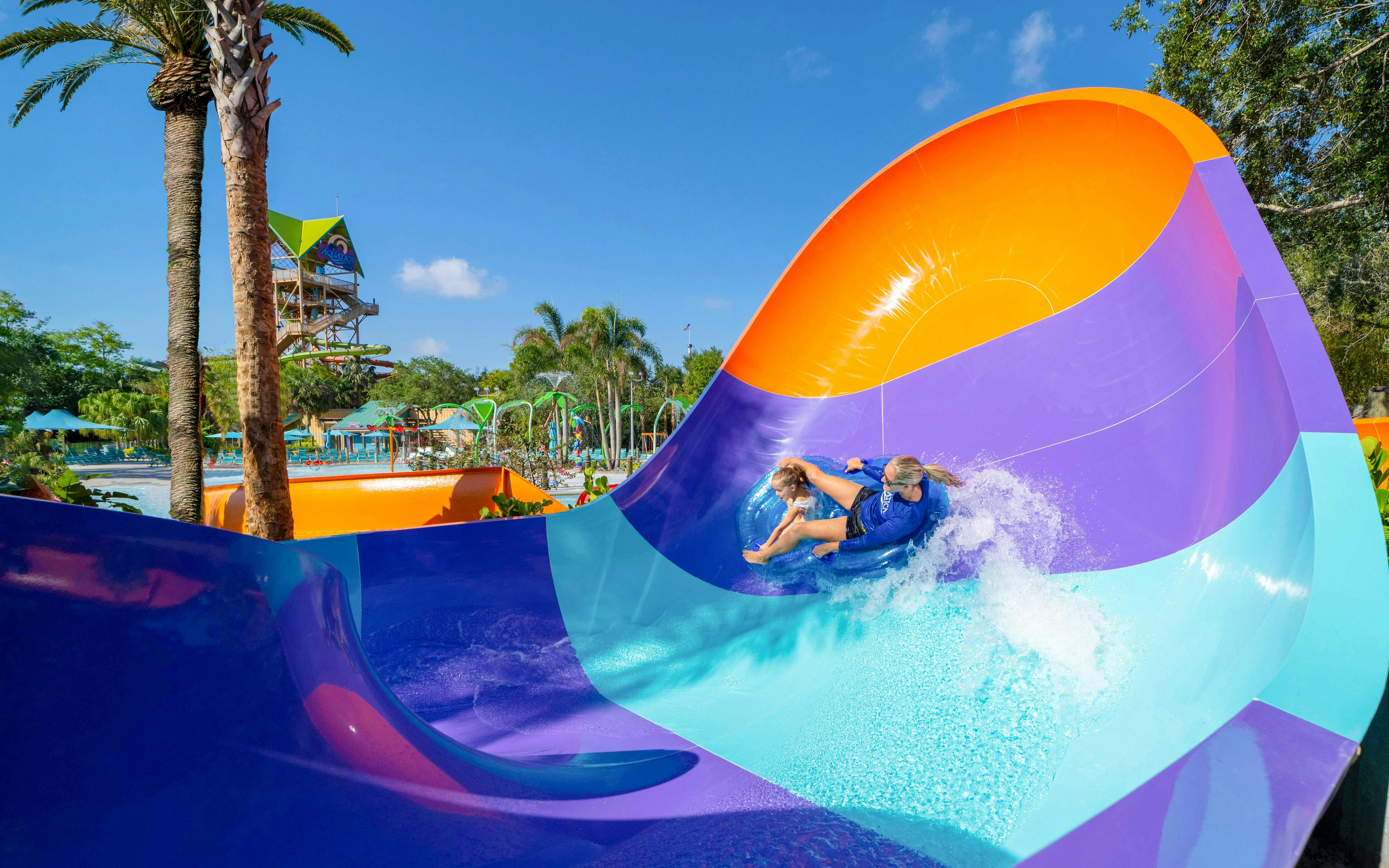 Water slide at Aquatica Orlando with people riding in a tube.
