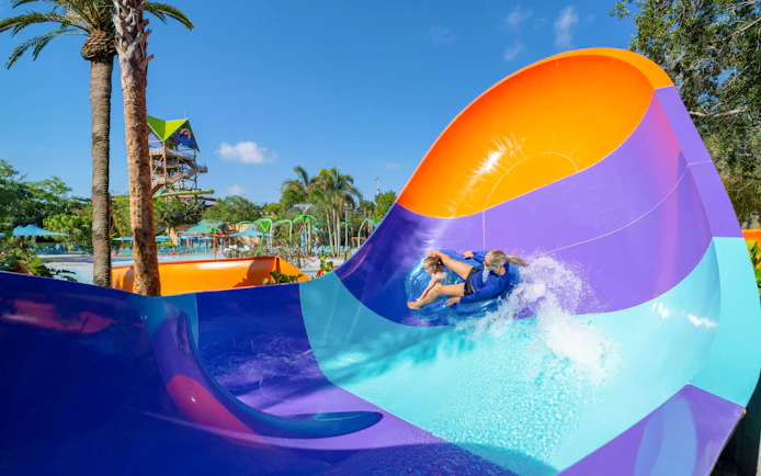 Water slide at Aquatica Orlando with people riding in a tube.