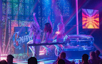 Stage performance of X Country - Kick'n Topless Revue in Vegas with dancers on stage.