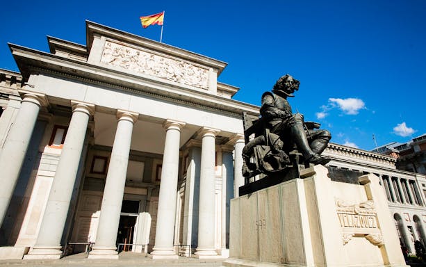 Museo Nacional del Prado entrance with Velázquez statue in Madrid.