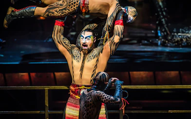 Performer lifting another in Cirque du Soleil KÀ show, Las Vegas.