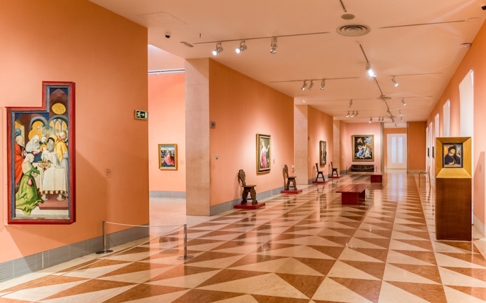 Thyssen Bornemisza Museum gallery room with paintings on display in Madrid.